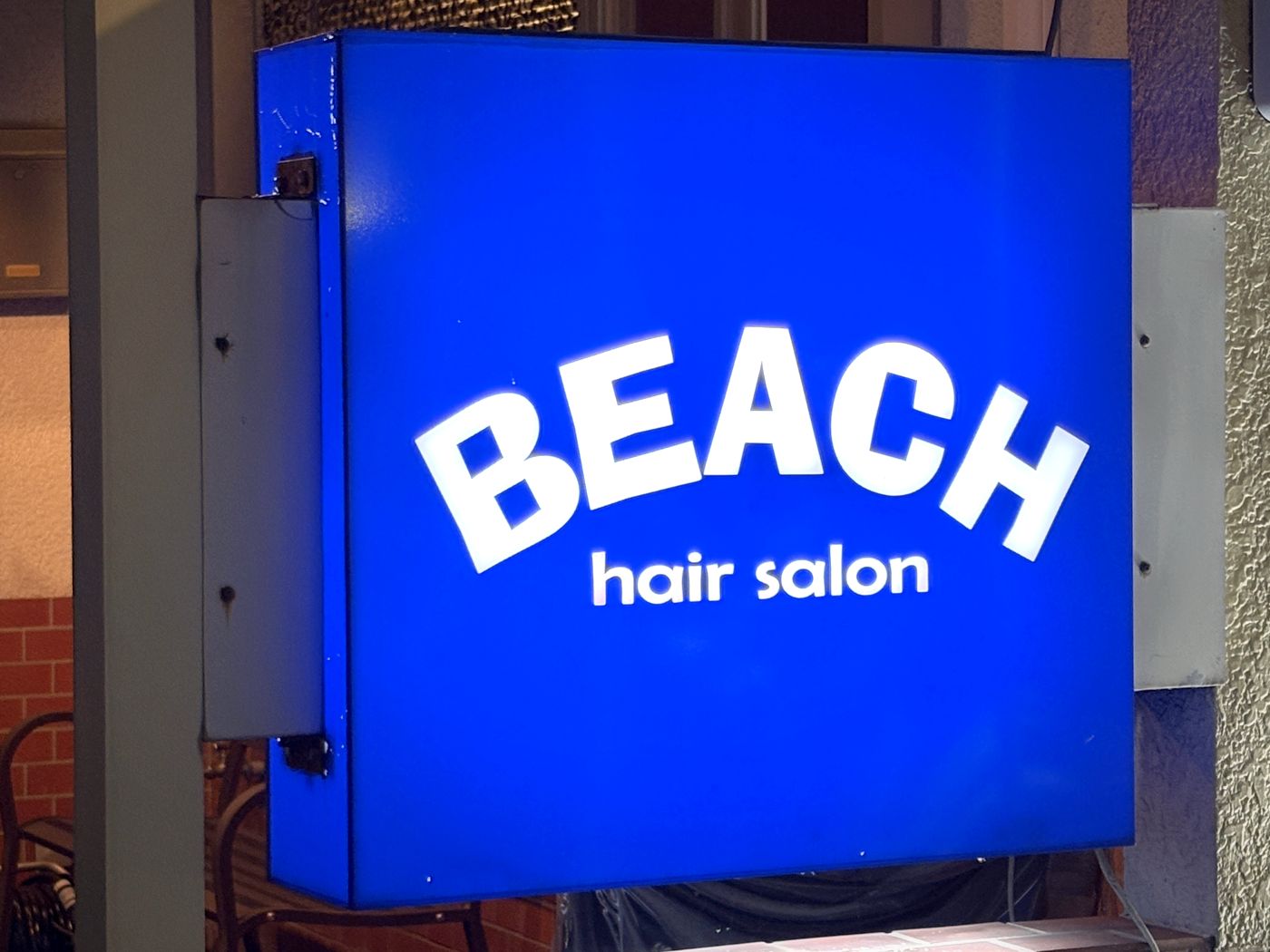 夜に光る、青いBEACH hair salonの袖看板